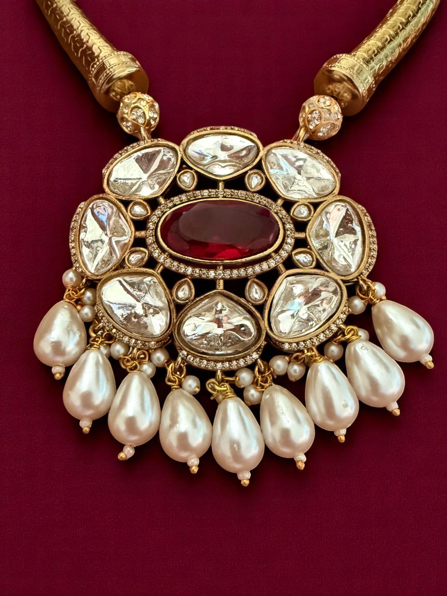 Regal Kundan Hasli Necklace Set with Ruby Red Centerpiece and Pearl Drop Accents
