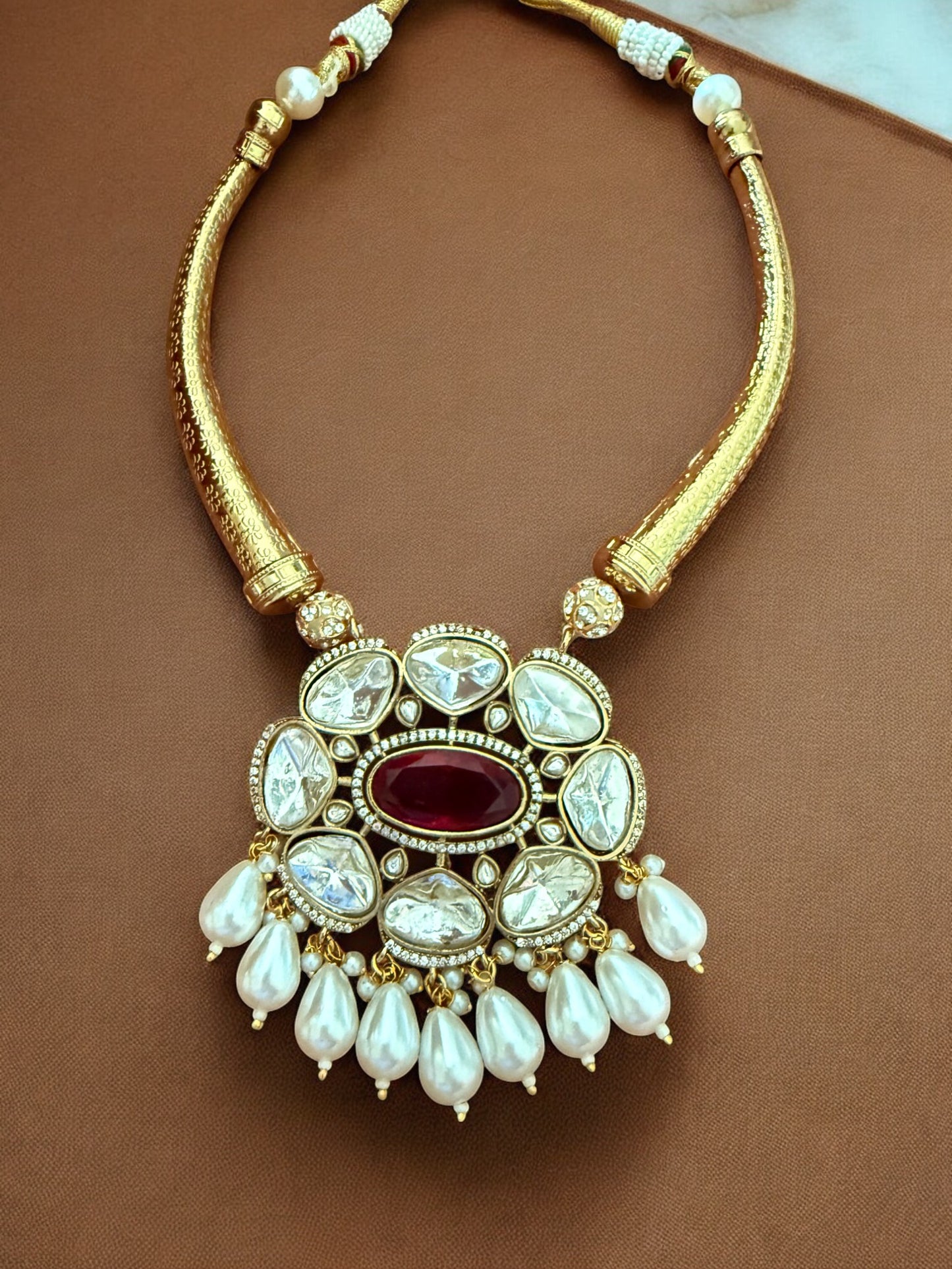Regal Kundan Hasli Necklace Set with Ruby Red Centerpiece and Pearl Drop Accents